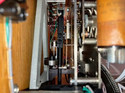 Pendulum installed in clock, with compensator near top of pendulum rod.