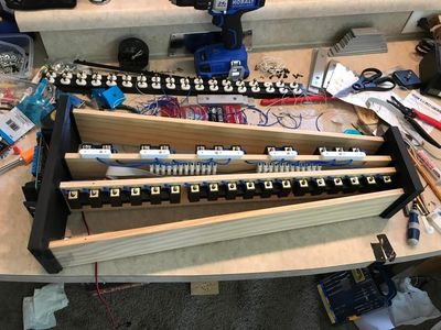 The white pieces are spacers to elevate the first row (the “black keys”) a little more.
