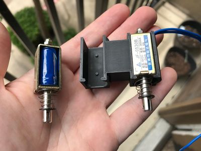 Rather than attempt to mount the solenoids directly to the wooden rails, I decided to 3D-print these plastic chassis they snap into.