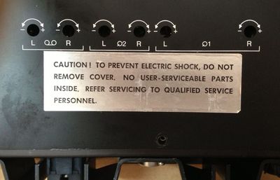 A label that reads Caution! To prevent electric shock, do not remove cover. No user-serviceable parts inside. Refer servicing to qualified service personnel.