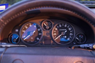 Custom Smiths-style gauge faces fitted to a Mazda Miata dashboard.