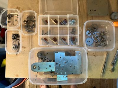 Parts in plastic compartmented storage containers.