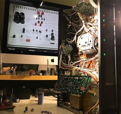 The stereo on its side with the main boards under repair in place.
