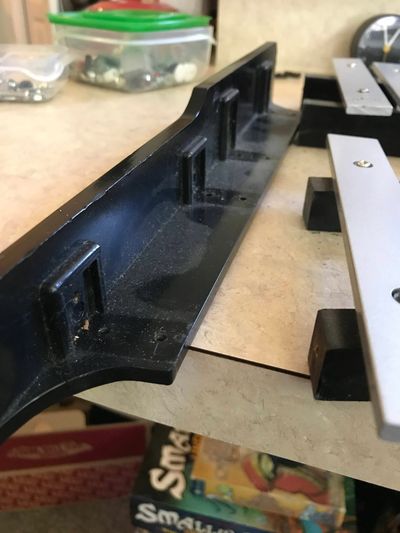 The original setup uses four wooden rails, two per row of bells, which fit into a plastic end piece on either side.