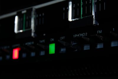 Closeup of the sliders and switches in dramatic lighting.